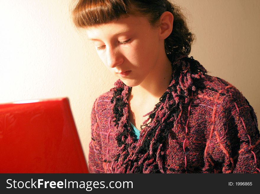 A young girl with her laptop computer on the internet. A young girl with her laptop computer on the internet.
