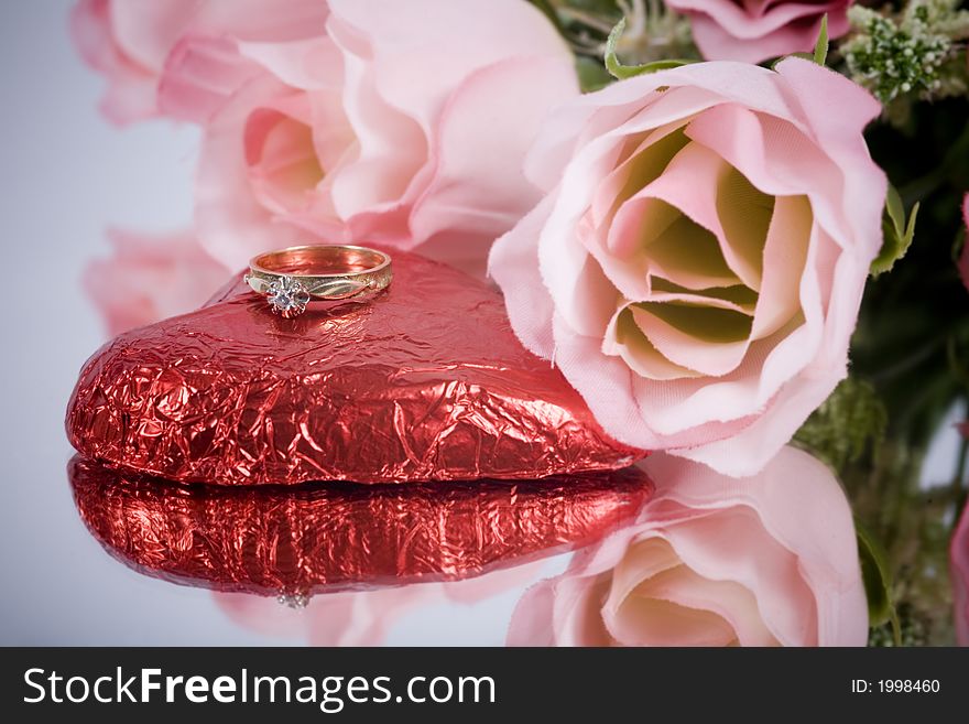 A gold engagement ring with heart and flowers