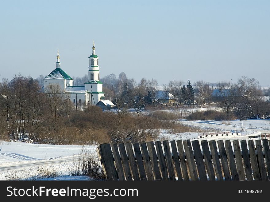 Kind of village with church on a background of the blue homogeneous sky. Kind of village with church on a background of the blue homogeneous sky