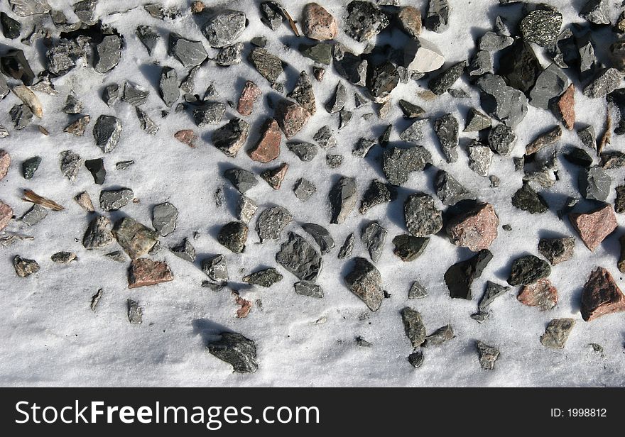 Stones in snow on a railway track