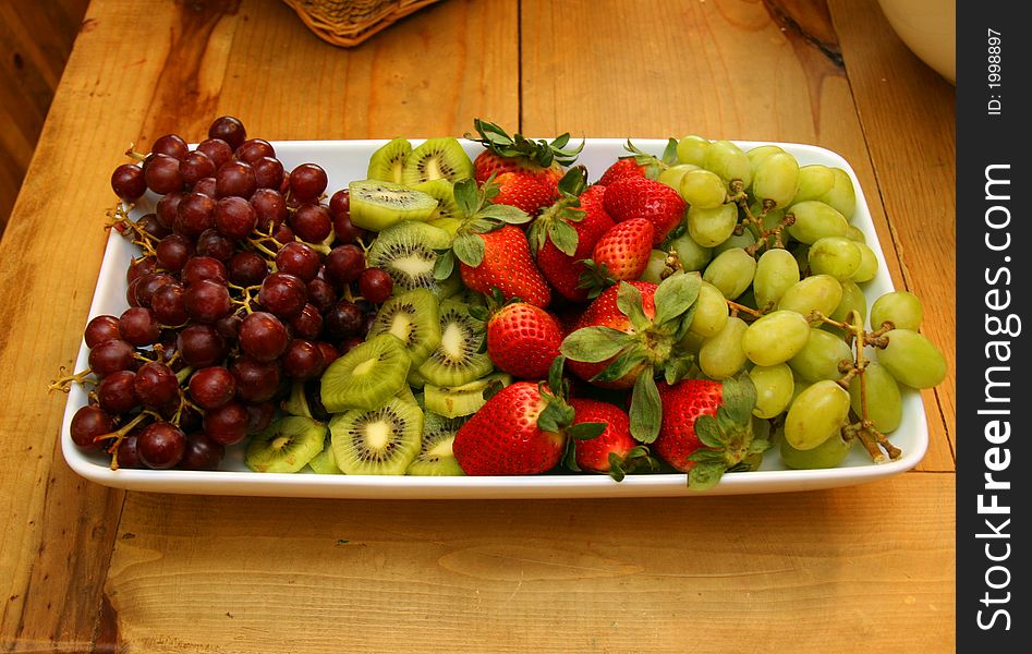 Grapes Kiwi and Strawberries on a Plate. Grapes Kiwi and Strawberries on a Plate