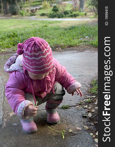 An 18 months old Israeli toddler playing in a puddle after the rain. An 18 months old Israeli toddler playing in a puddle after the rain.