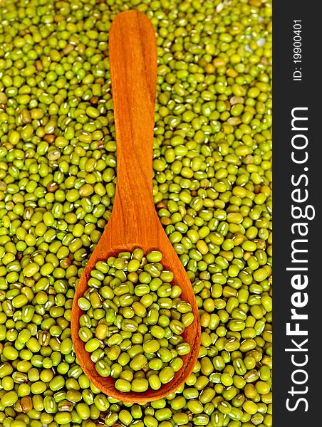 Mung beans over wooden spoon