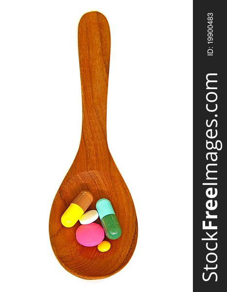 Wooden Spoon With Pills Isolated