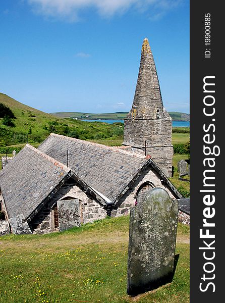 View of St Enodoc Church in Trebetherick, North Cornwall, with the River Camel in the background. View of St Enodoc Church in Trebetherick, North Cornwall, with the River Camel in the background