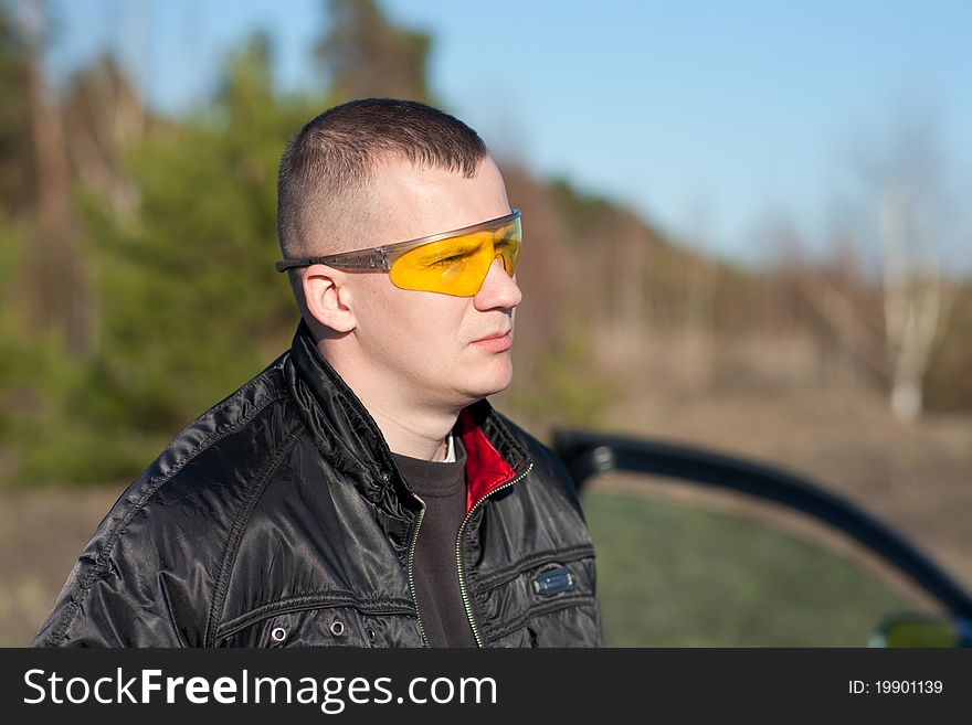 Young fashion man with attitude and modern broken glasses