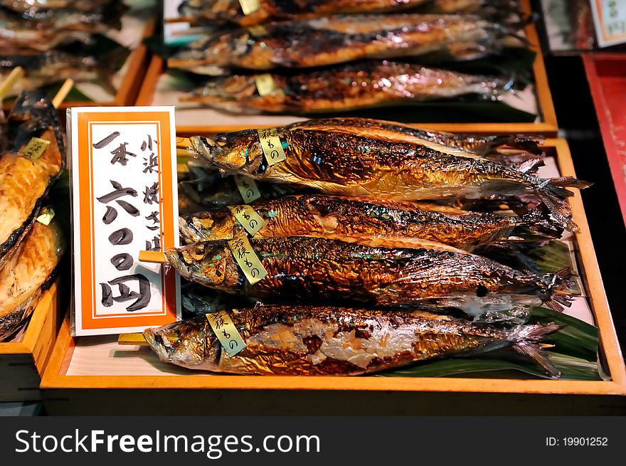 Fresh smoked fishes on counter. The tag in japanese is attached