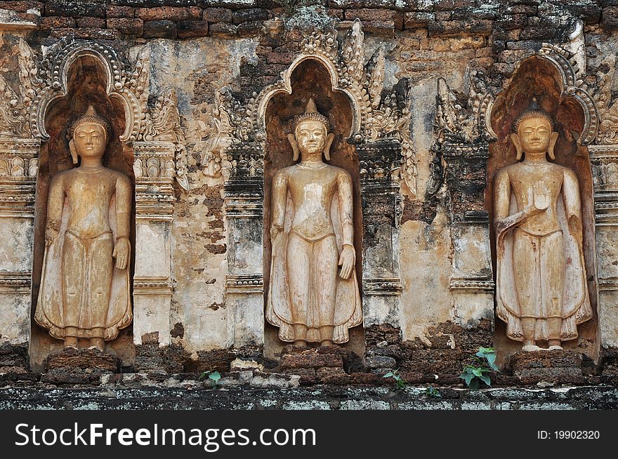 Standing Buddha on chedi 'Suwan Chang Kot' of Wat Ku Kut (Wat Jam Thewee), Lamphun Thailand. Standing Buddha on chedi 'Suwan Chang Kot' of Wat Ku Kut (Wat Jam Thewee), Lamphun Thailand