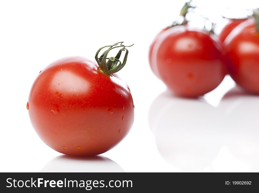 Red tomatoes on a white background. Red tomatoes on a white background