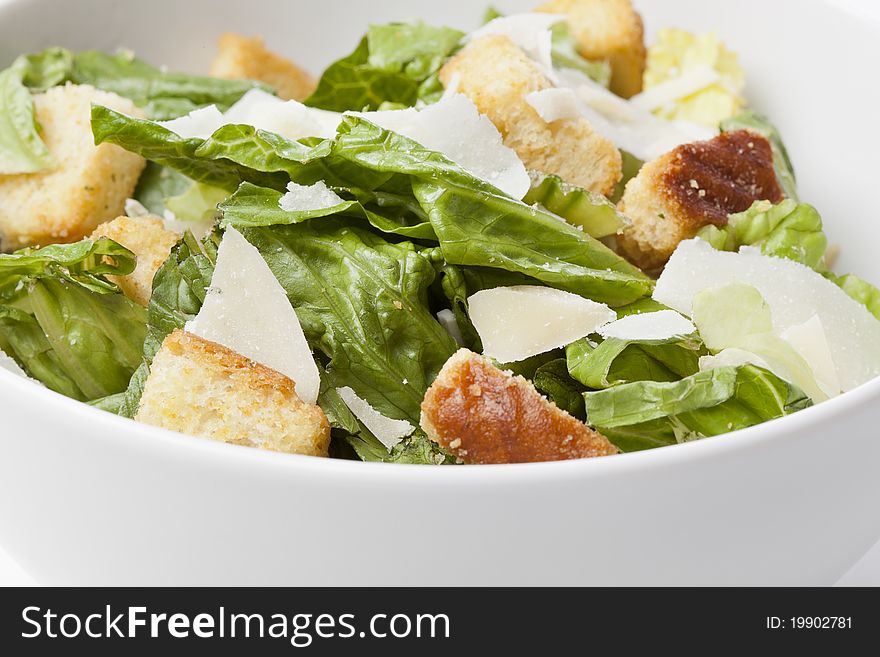 A Green Salad With Croutons And Cheese