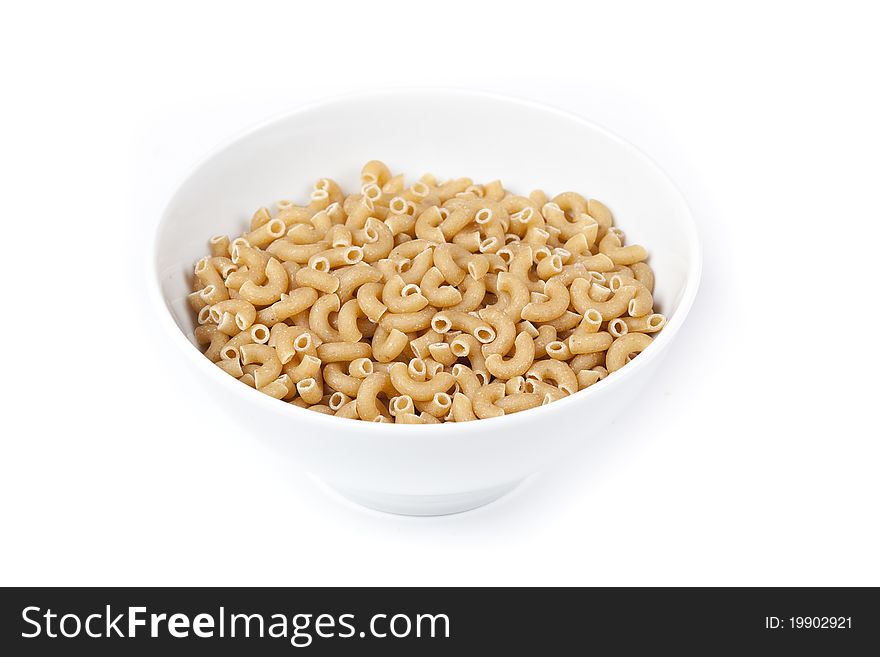 Dry macaroni pasta on a white back ground