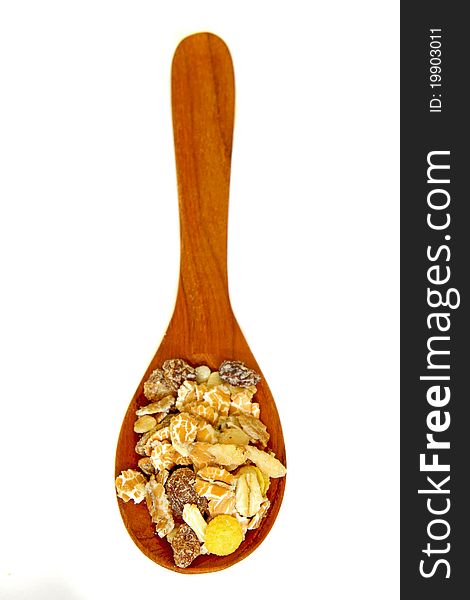 Cereal muesli on wooden spoon isolated on white background