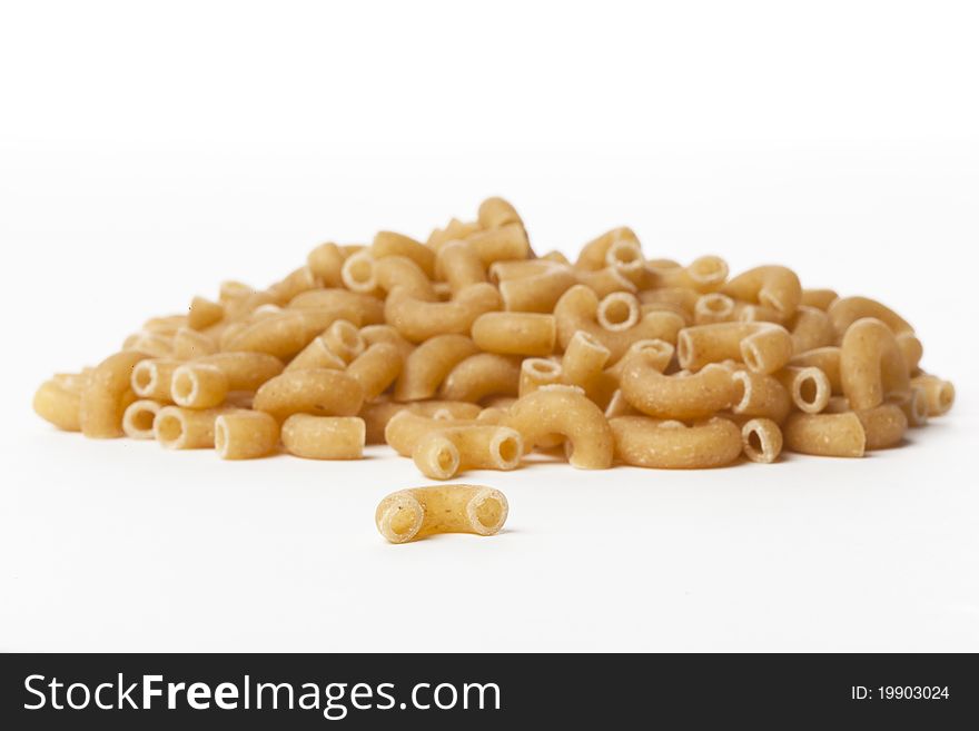 Dry macaroni pasta on a white back ground