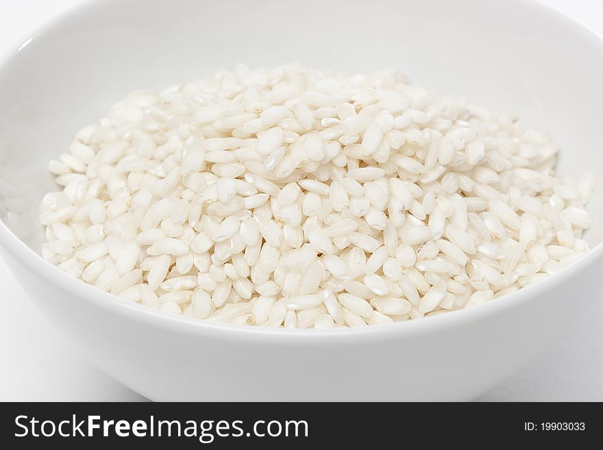 Dry white rice against a white background