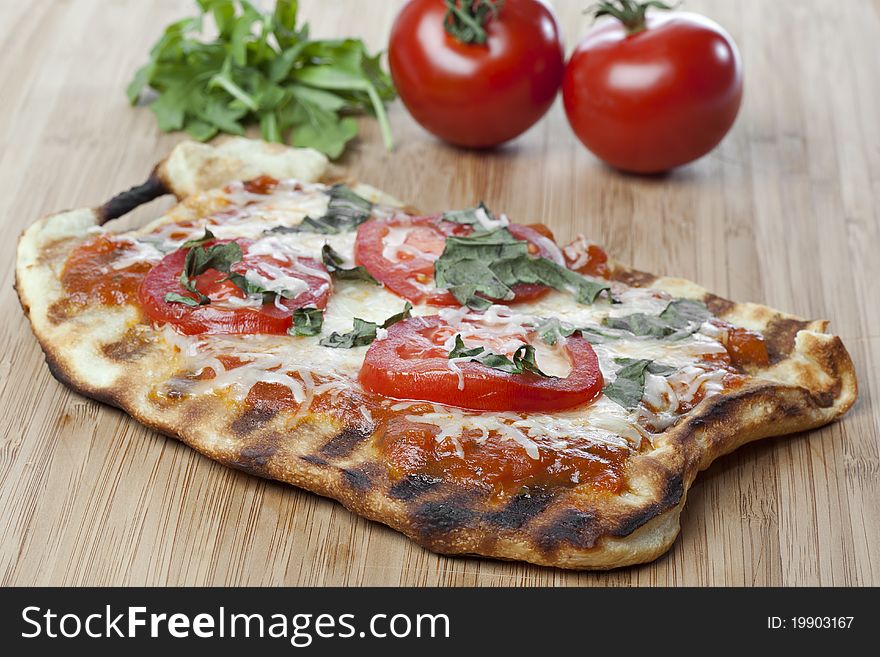 Fresh Homemade margarita pizza with tomatoes, cheese, and basil