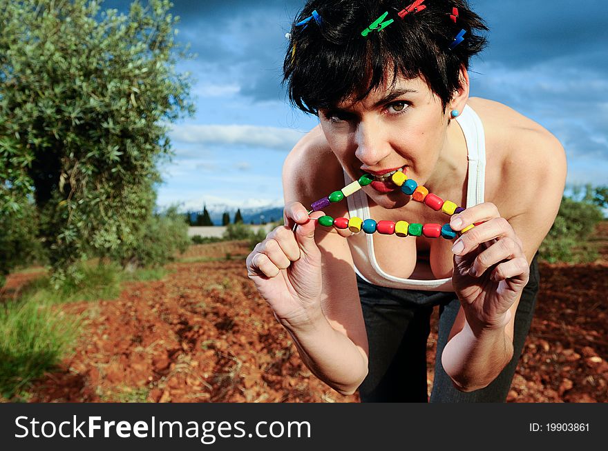 Woman with colored necklace in the forest