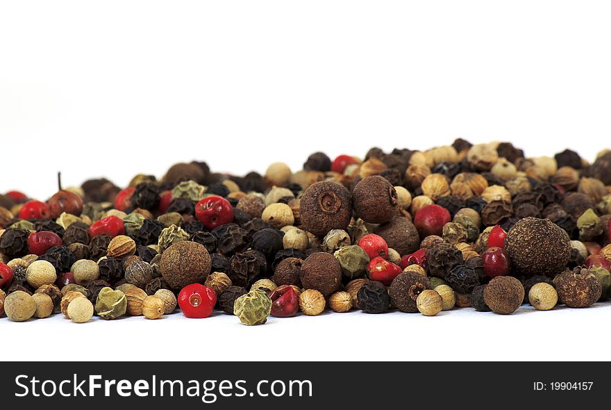 A close up of several types of peppercorns