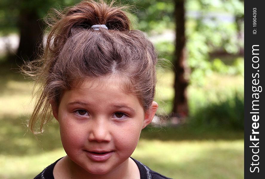 Portrait of a pretty little girl outside with a ponytail. Portrait of a pretty little girl outside with a ponytail