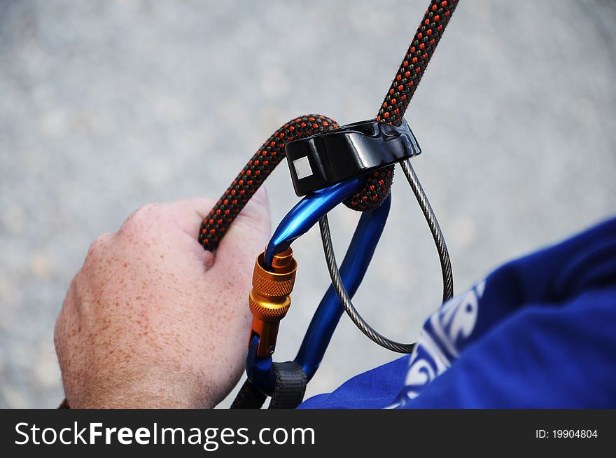 A man holding and secures a climbing rope. A man holding and secures a climbing rope.
