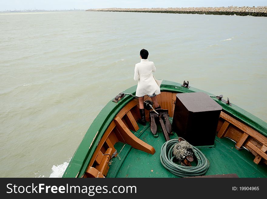 Woman in prow of a ship in Cádiz, Andalusia, Spain