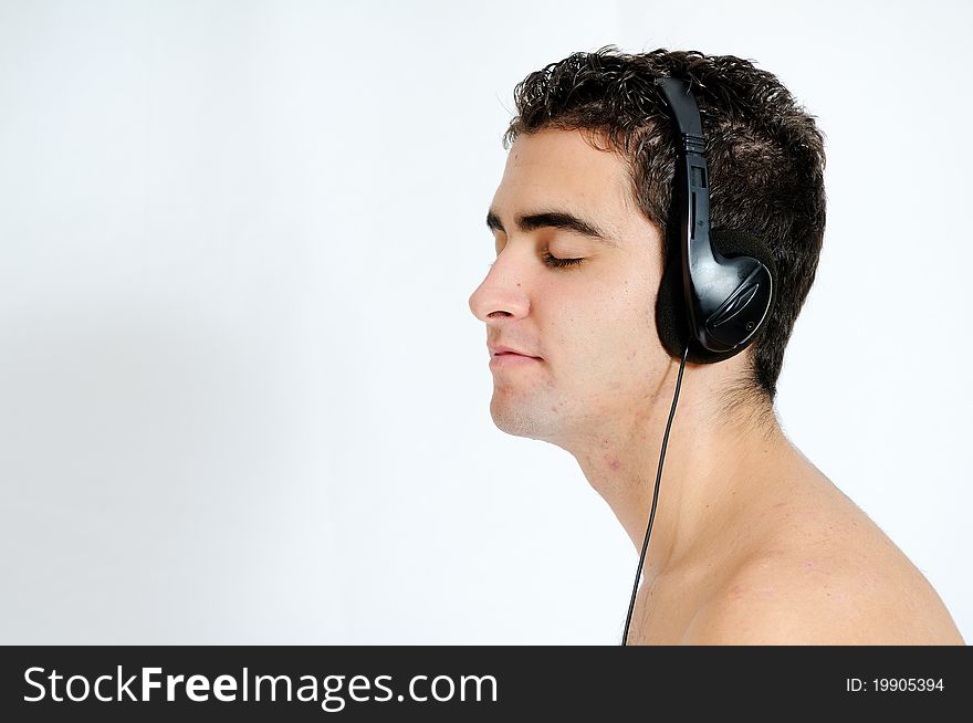 Young man listening to music with headphones. Young man listening to music with headphones