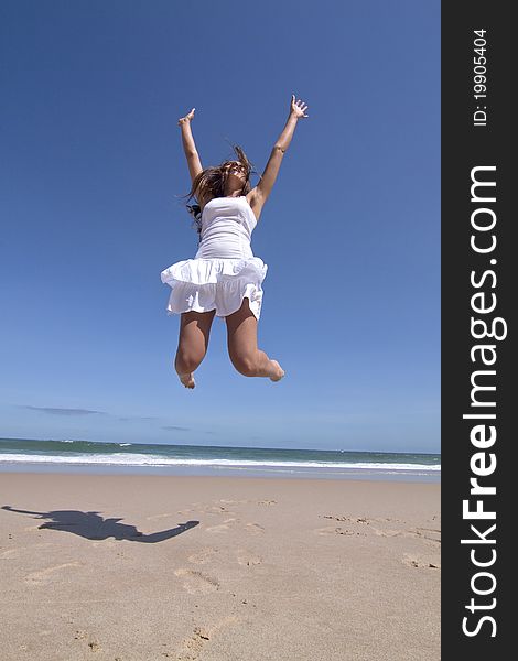 Woman jumping on the beach