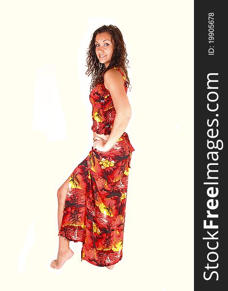 Teenager in a colorful long dress standing in the studio with brunette curly hair, for white background. Teenager in a colorful long dress standing in the studio with brunette curly hair, for white background.