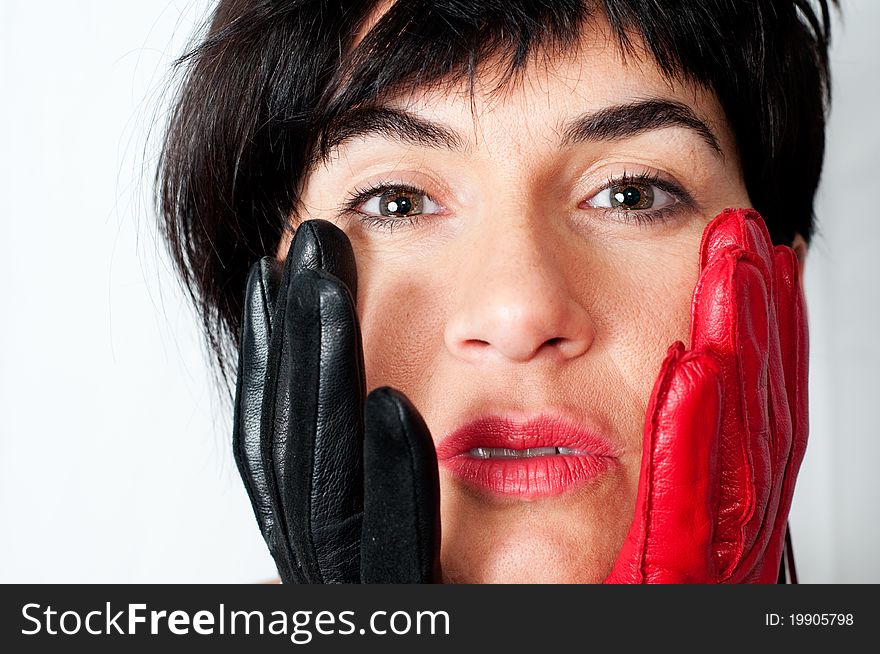 A girl with red and black gloves with a look of surprise.