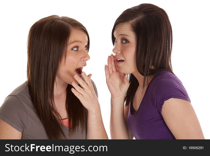 A teen is telling her friend a secret and she is shocked.