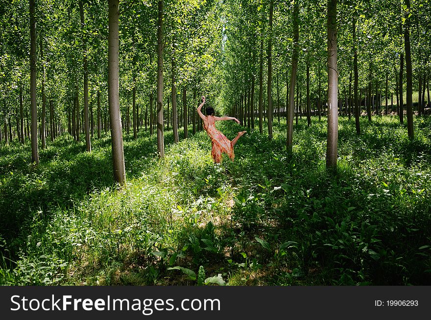 A woman dancing in the forest. A woman dancing in the forest