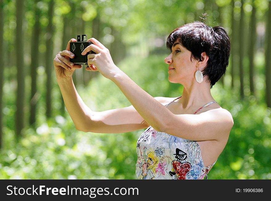 Woman taking a selfportrait with a old camera