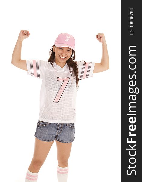 A woman showing her muscles while wearing her jersey. A woman showing her muscles while wearing her jersey.