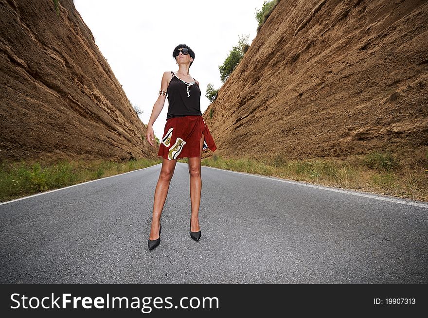 A woman with sunglasses on the road. A woman with sunglasses on the road