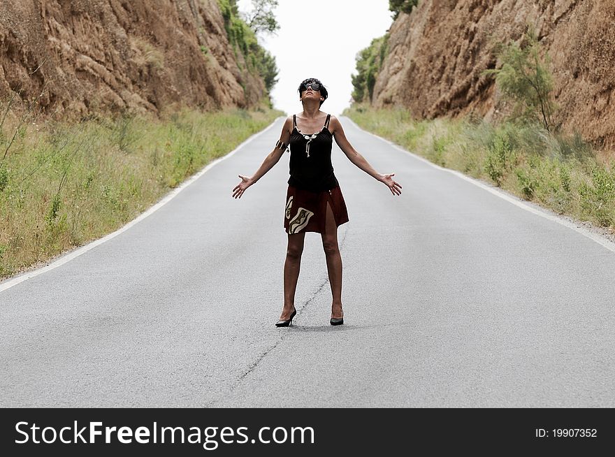 A pretty woman on a narrow road. A pretty woman on a narrow road