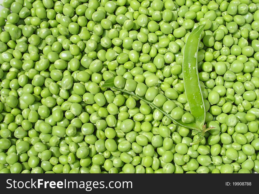 A lot of cleaned green peas with pod in the middle