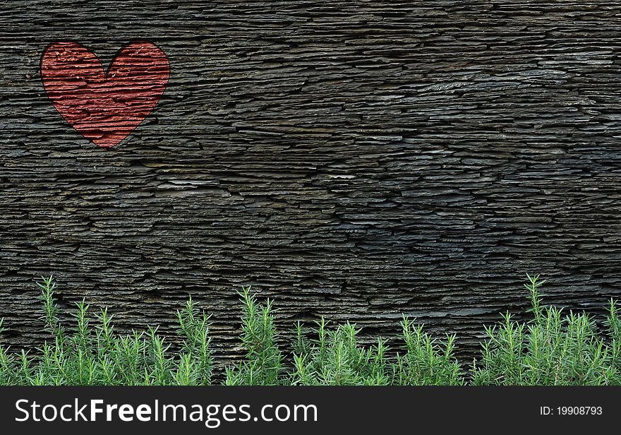 A rock layered wall with red heart. A rock layered wall with red heart