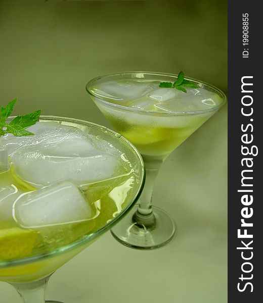 Alcohol yellow liqueur cocktail with ice and lemon. Alcohol yellow liqueur cocktail with ice and lemon