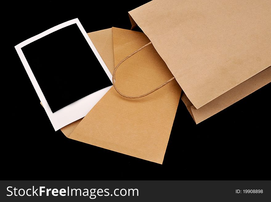 A vintage envelope in a paper bag with instant photo inside. A vintage envelope in a paper bag with instant photo inside