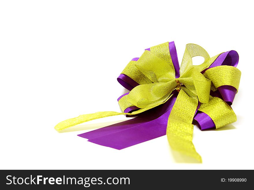 Gold and violet ribbon bow isolated on white background.