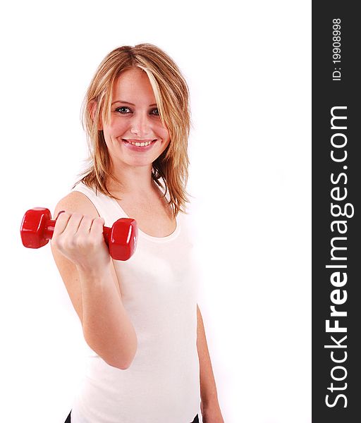 Exercising young woman in white shirt with red fitness weights
