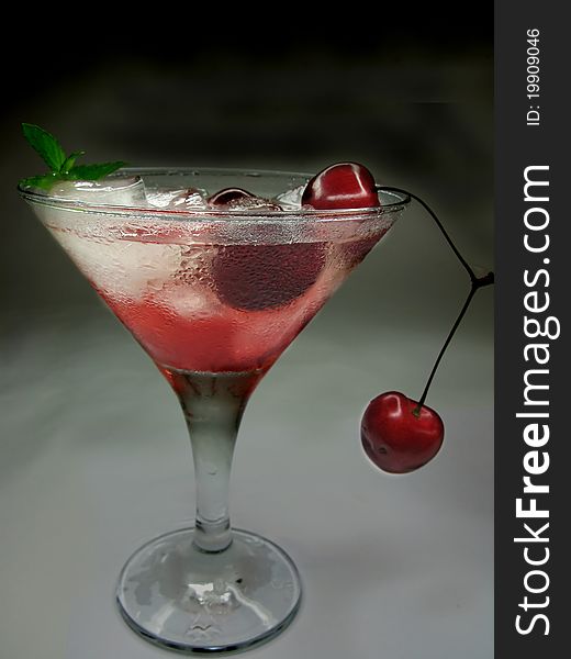 Alcohol red liqueur cocktail with ice and cherry. Alcohol red liqueur cocktail with ice and cherry