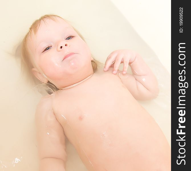 Adorable baby taking bath and swim