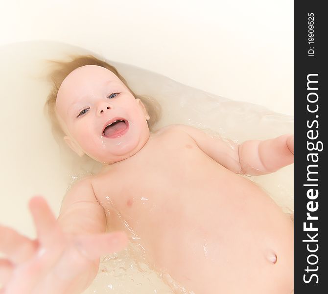 Adorable baby taking bath and swim