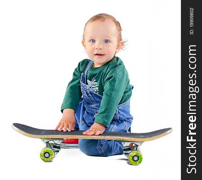 Cute 1 years old boy on a skateboard in the studio. Cute 1 years old boy on a skateboard in the studio