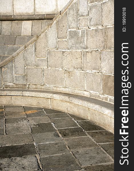 Close-up curve section of a granite stone wall and floor background