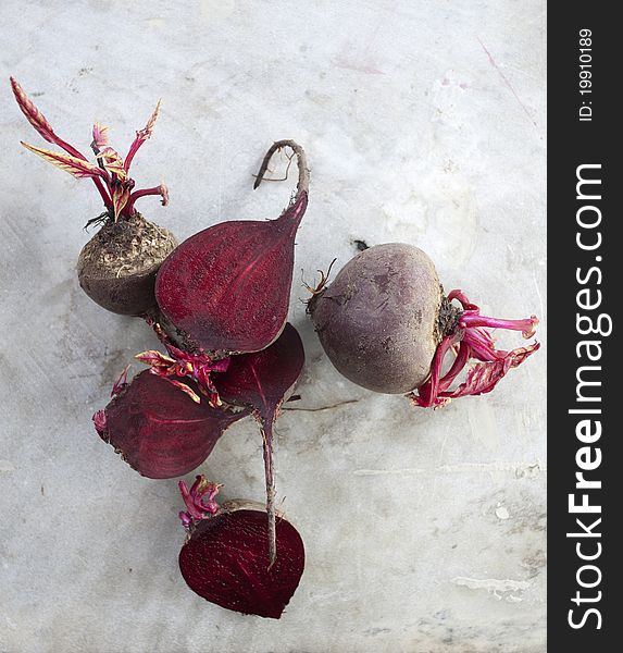 Frehsly harvested beetroot on a marble background. Some pieces are sliced. Frehsly harvested beetroot on a marble background. Some pieces are sliced.