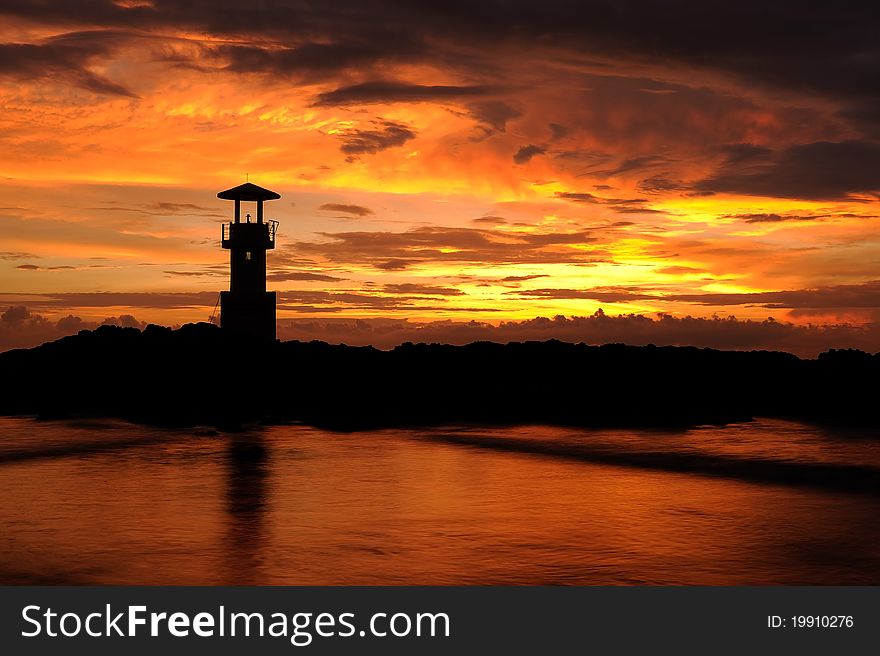 A lighthouse in Thailand under the sunset sky. A lighthouse in Thailand under the sunset sky