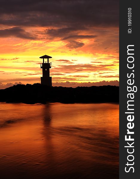 A lighthouse in Thailand under the sunset sky. A lighthouse in Thailand under the sunset sky