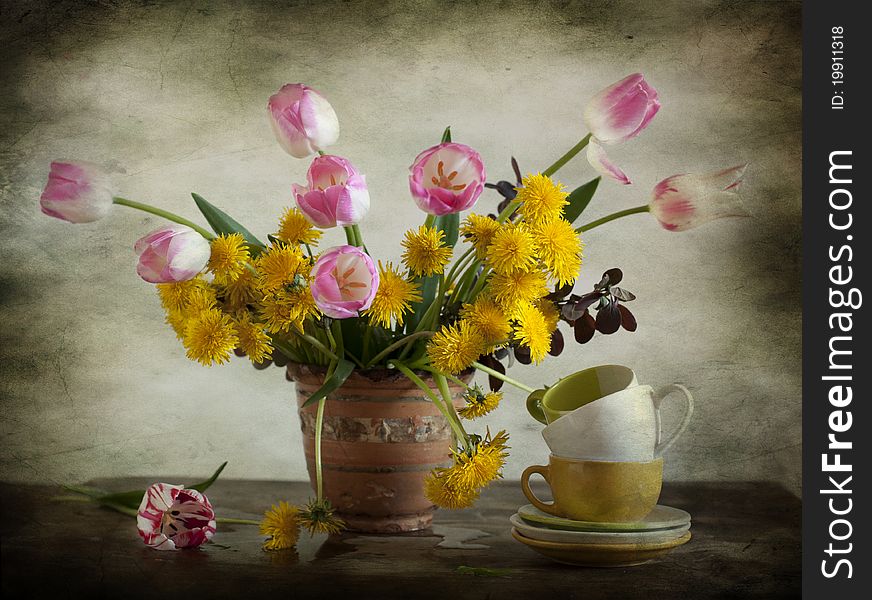 A bouquet consists of dandelions and tulips, cups cost alongside