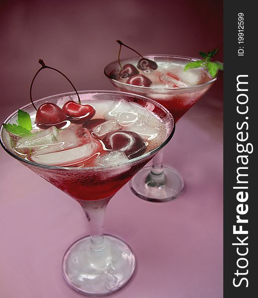 Alcohol red liqueur cocktail with ice and cherry. Alcohol red liqueur cocktail with ice and cherry